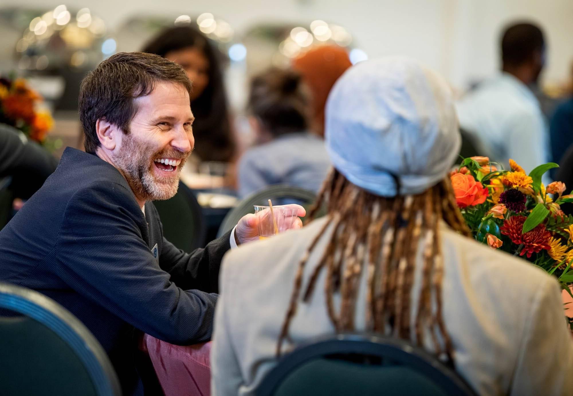 People laughing together at a table